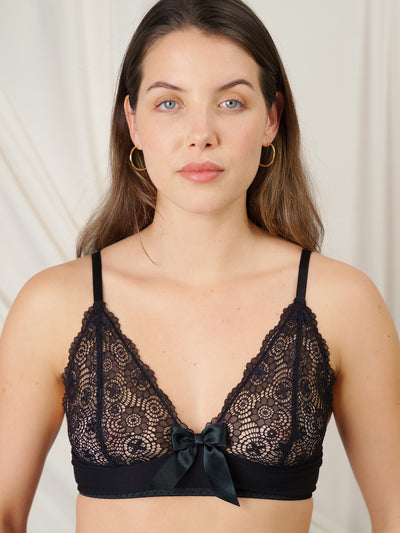 Non-wired, un-padded bralette with adjustable straps and black satin bow