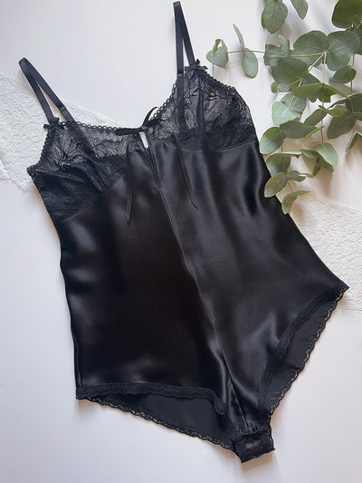 Vintage-inspired black silk teddy with floral lace detailing and flattering bias cut for an elegant silhouette